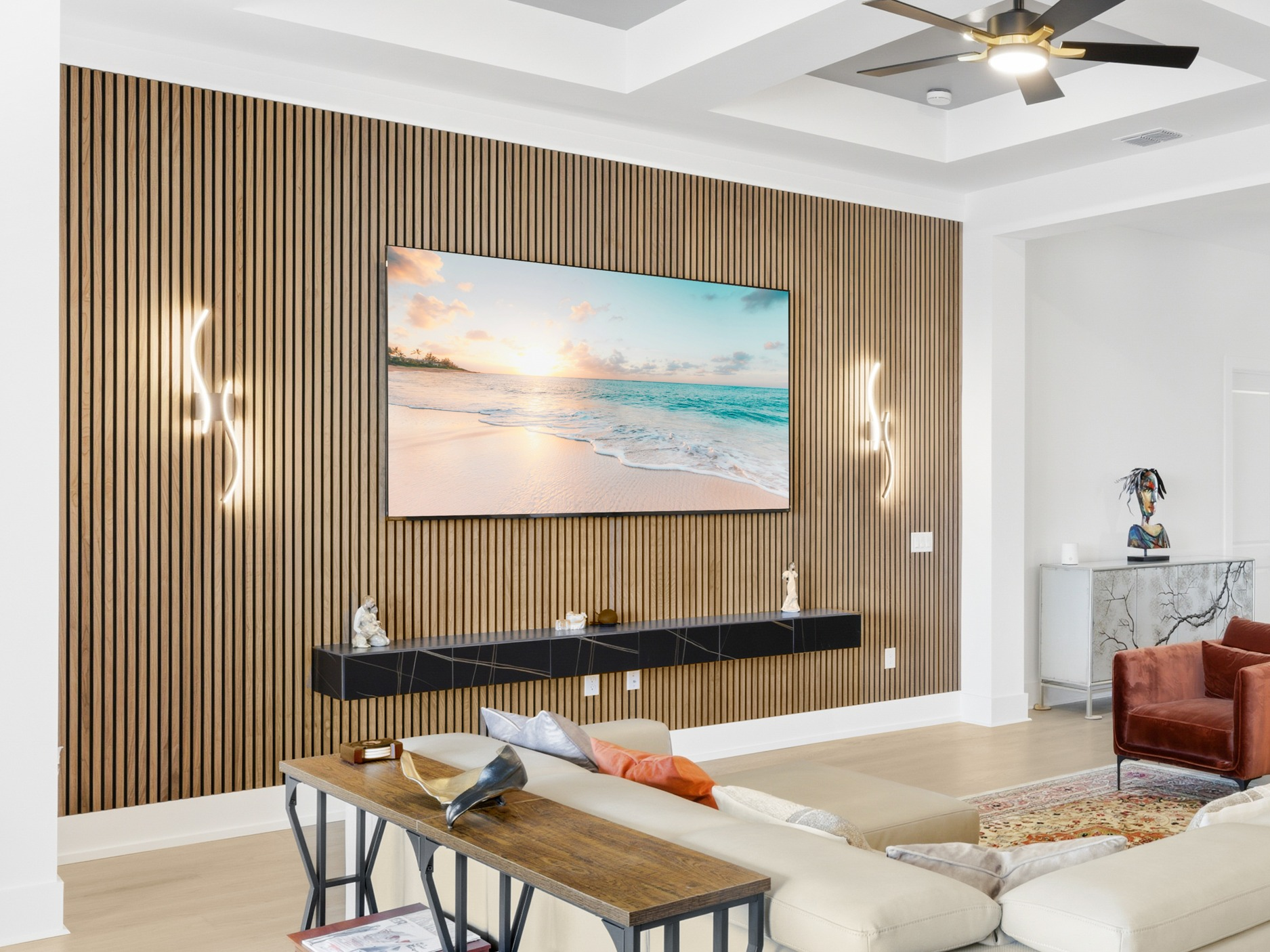 Wood slat accent wall with sconces and floating console by Trim My Crib