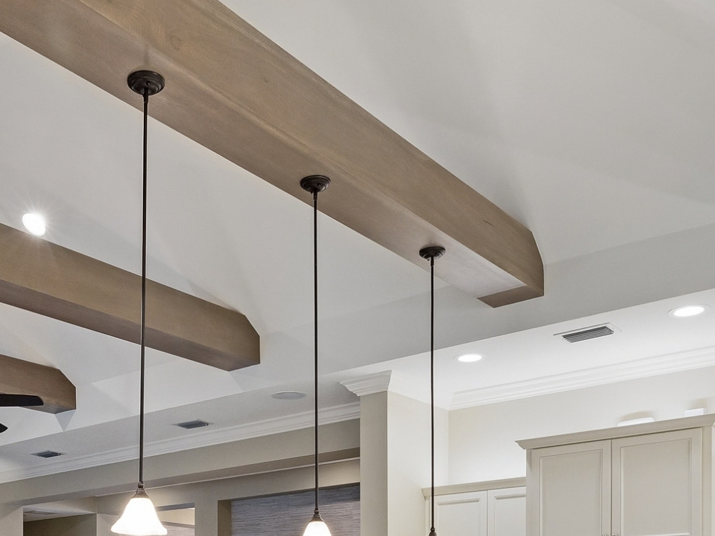 Wood ceiling beams with pendant lights by Trim My Crib