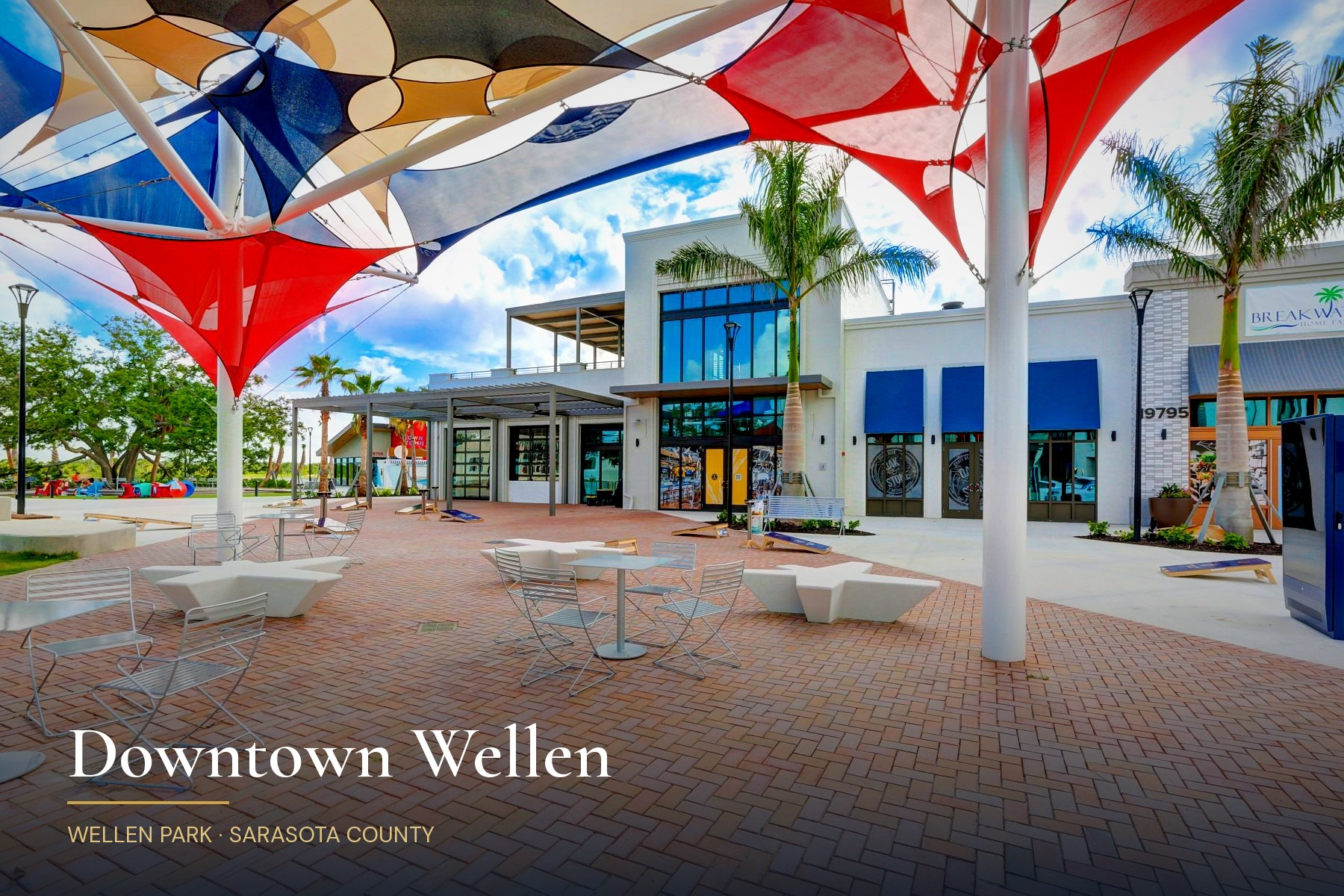 Downtown Wellen plaza in Wellen Park with colorful shade sails, palm trees, and outdoor cafe seating, captioned Downtown Wellen